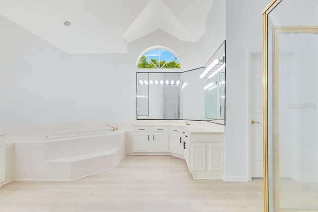 5913 Masters Blvd, Orlando, FL 32819 - bathroom featuring wood finished floors, a garden tub, and vanity