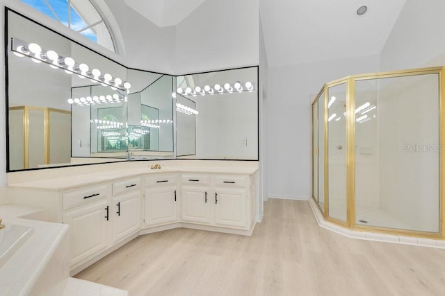 5913 Masters Blvd, Orlando, FL 32819 - bathroom with wood finished floors, a stall shower, vanity, a bath, and lofted ceiling