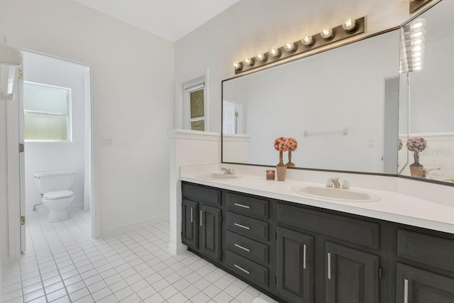 5913 Masters Blvd, Orlando, FL 32819 - bathroom with double vanity, tile patterned floors, and toilet