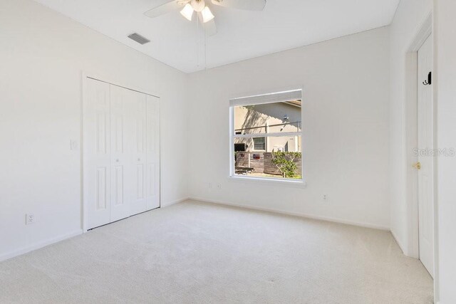 5913 Masters Blvd, Orlando, FL 32819 - unfurnished bedroom featuring carpet, a closet, ceiling fan, and baseboards