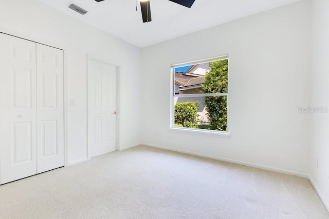 5913 Masters Blvd, Orlando, FL 32819 - unfurnished bedroom with carpet flooring, a closet, ceiling fan, and baseboards