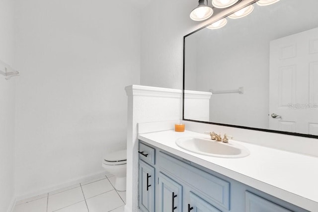 5913 Masters Blvd, Orlando, FL 32819 - half bathroom featuring toilet, vanity, tile patterned flooring, and baseboards