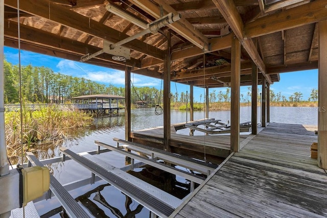5913 Masters Blvd, Orlando, FL 32819 - dock area featuring boat lift, a water view, and view of wooded area