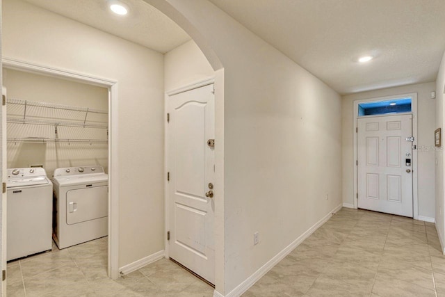 868 Brooklet Dr, Davenport, FL 33837 - washroom featuring washer and dryer, arched walkways, baseboards, and recessed lighting
