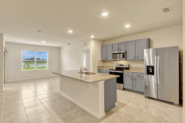 868 Brooklet Dr, Davenport, FL 33837 - kitchen featuring appliances with stainless steel finishes, a sink, gray cabinets, light tile patterned flooring, and tasteful backsplash