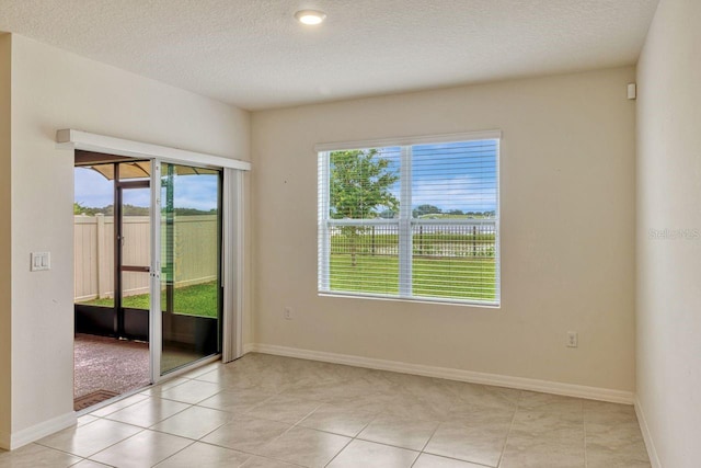 868 Brooklet Dr, Davenport, FL 33837 - unfurnished room with healthy amount of natural light, a textured ceiling, and baseboards