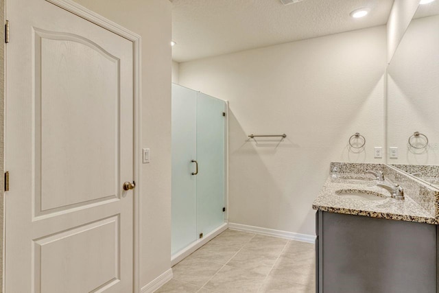 868 Brooklet Dr, Davenport, FL 33837 - bathroom with double vanity, baseboards, a stall shower, and a textured ceiling