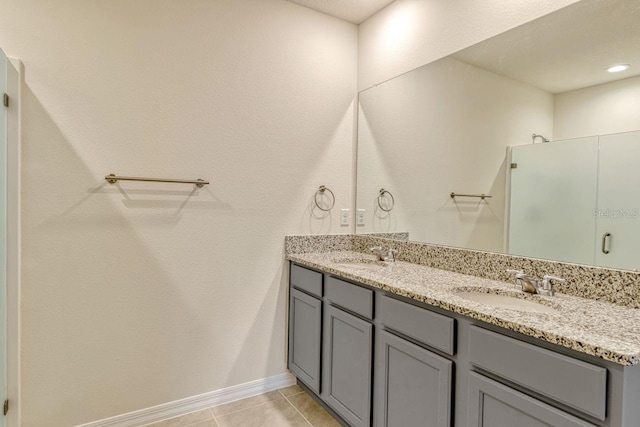 868 Brooklet Dr, Davenport, FL 33837 - full bath with double vanity, baseboards, tile patterned flooring, and a shower with door
