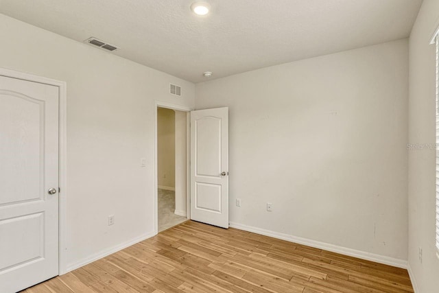 868 Brooklet Dr, Davenport, FL 33837 - unfurnished bedroom featuring light wood-type flooring and baseboards