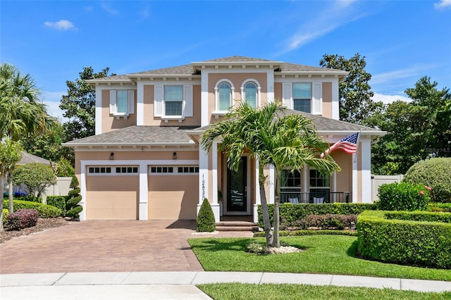 12530 Climbing Vine Ct, Windermere, FL 34786 - view of front of property featuring a garage, stucco siding, decorative driveway, and a front lawn