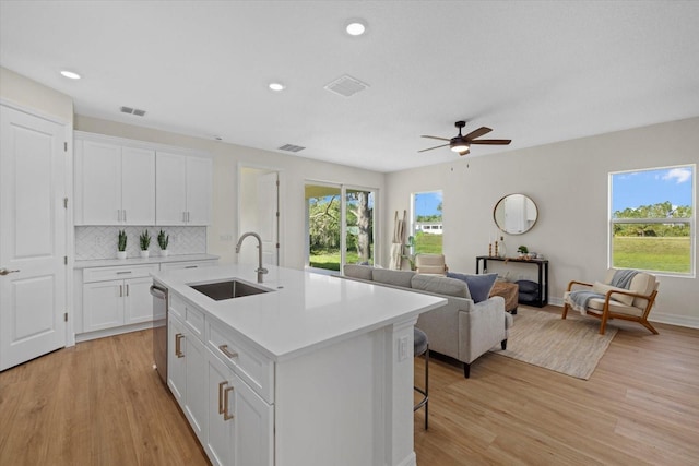 2682 Edwin Ave, North Port, FL 34288 - kitchen featuring a sink, dishwasher, light countertops, light wood-type flooring, and recessed lighting