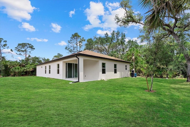 2682 Edwin Ave, North Port, FL 34288 - back of property featuring stucco siding and a lawn