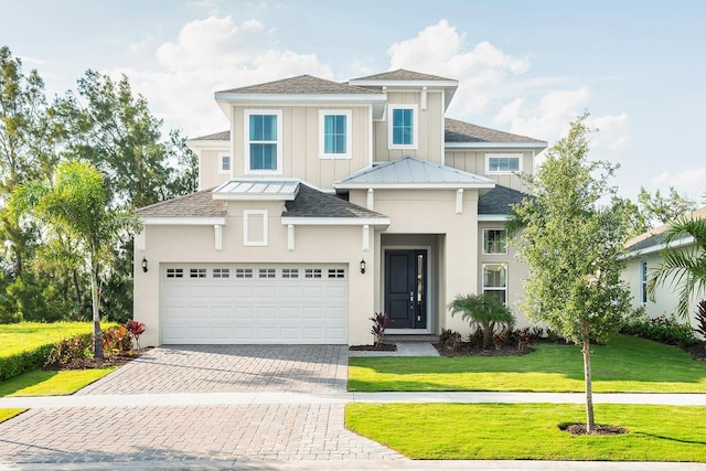 1031 Signet, Apollo Beach, FL 33572 - view of front of property featuring decorative driveway, a front yard, roof with shingles, and board and batten siding