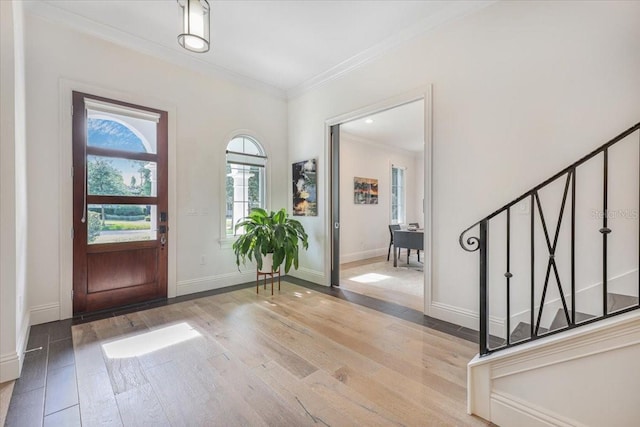 521 S Phelps Ave, Winter Park, FL 32789 - entrance foyer featuring ornamental molding, wood-type flooring, baseboards, and stairs
