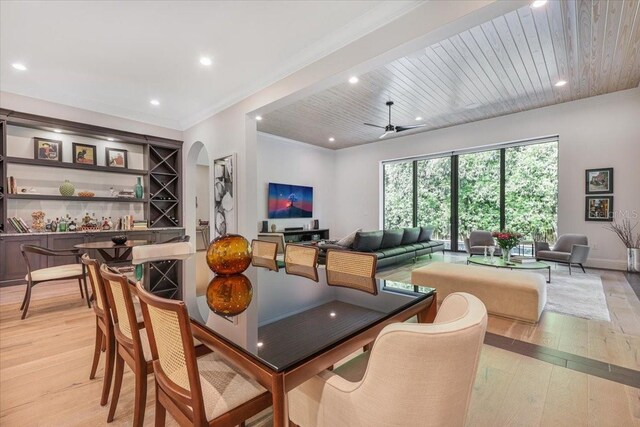 521 S Phelps Ave, Winter Park, FL 32789 - dining area featuring light wood-style flooring, arched walkways, recessed lighting, a ceiling fan, and crown molding