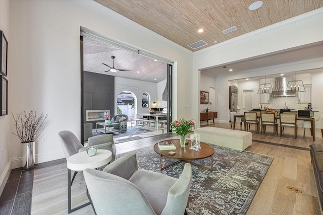 521 S Phelps Ave, Winter Park, FL 32789 - living room with wood ceiling, ornamental molding, wood finished floors, baseboards, and recessed lighting