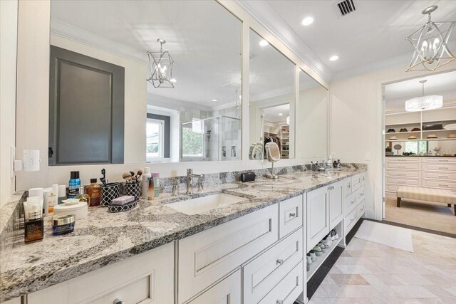 521 S Phelps Ave, Winter Park, FL 32789 - bathroom featuring a chandelier, ornamental molding, a stall shower, double vanity, and recessed lighting