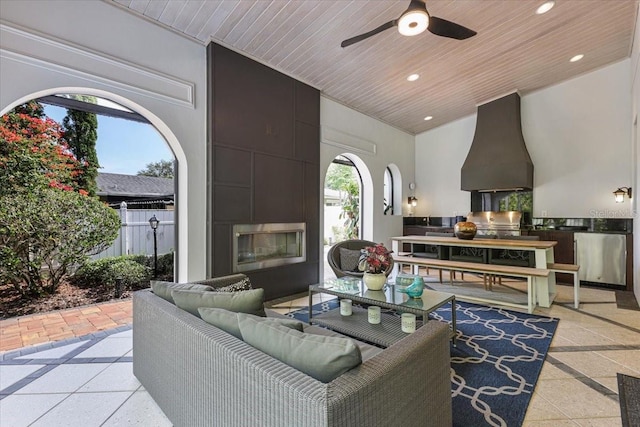 521 S Phelps Ave, Winter Park, FL 32789 - living room with wooden ceiling, recessed lighting, a ceiling fan, a fireplace, and plenty of natural light