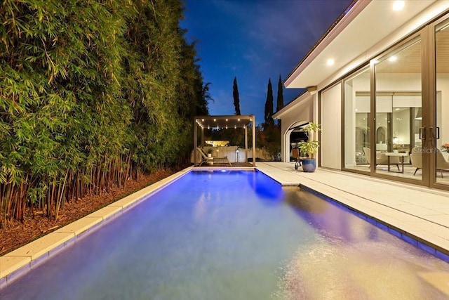 521 S Phelps Ave, Winter Park, FL 32789 - pool at night featuring an outdoor pool and a patio area