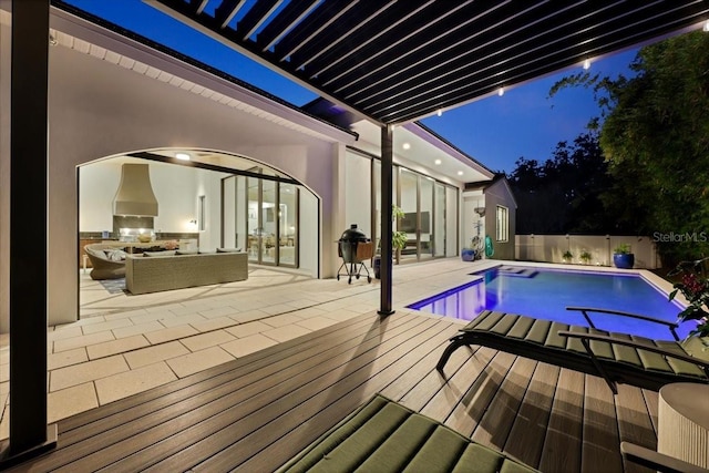 521 S Phelps Ave, Winter Park, FL 32789 - pool at twilight with an outdoor kitchen, outdoor lounge area, and a patio area