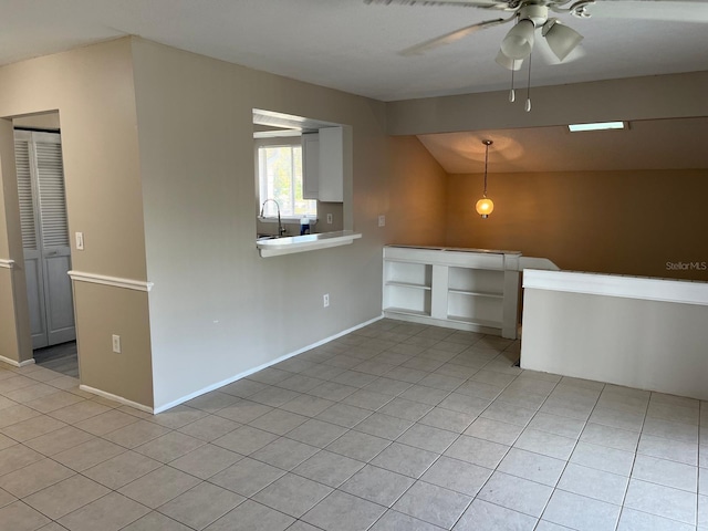 4596 Pheasant Run Dr Unit C, Orlando, FL 32808 - spare room featuring vaulted ceiling, light tile patterned flooring, a ceiling fan, a sink, and baseboards