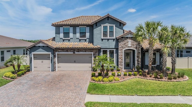 29043 Picana Ln, Wesley Chapel, FL 33543 - view of front of house with stone siding, a tile roof, and stucco siding