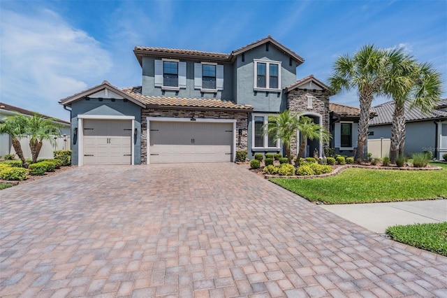 29043 Picana Ln, Wesley Chapel, FL 33543 - view of front facade featuring stone siding, decorative driveway, a tiled roof, and stucco siding