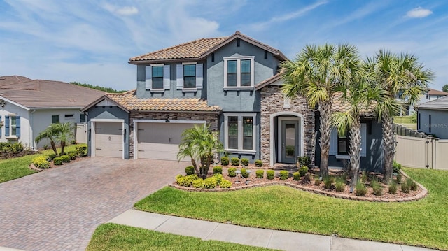 29043 Picana Ln, Wesley Chapel, FL 33543 - view of front of house featuring stone siding, decorative driveway, stucco siding, a tile roof, and a garage