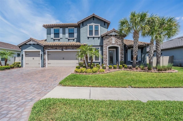 29043 Picana Ln, Wesley Chapel, FL 33543 - view of front of property featuring stucco siding, stone siding, decorative driveway, a front lawn, and a tiled roof