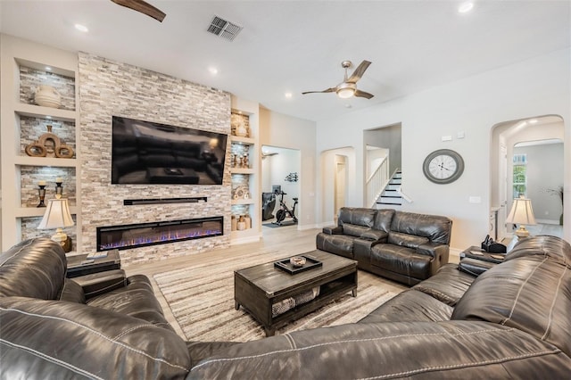 29043 Picana Ln, Wesley Chapel, FL 33543 - living area featuring a ceiling fan, arched walkways, built in shelves, baseboards, and recessed lighting