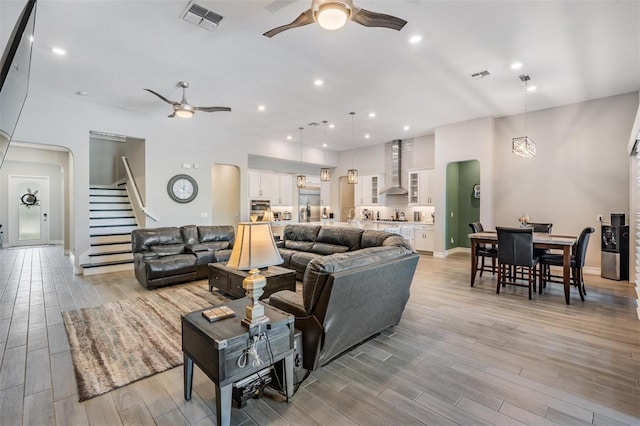 29043 Picana Ln, Wesley Chapel, FL 33543 - living area with a ceiling fan, stairway, light wood-type flooring, recessed lighting, and arched walkways