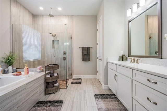 29043 Picana Ln, Wesley Chapel, FL 33543 - bathroom with a shower stall, a garden tub, vanity, and baseboards