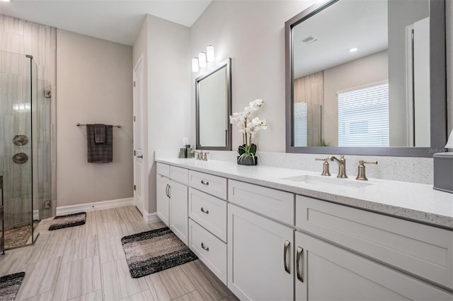 29043 Picana Ln, Wesley Chapel, FL 33543 - bathroom with double vanity, a shower stall, baseboards, and recessed lighting