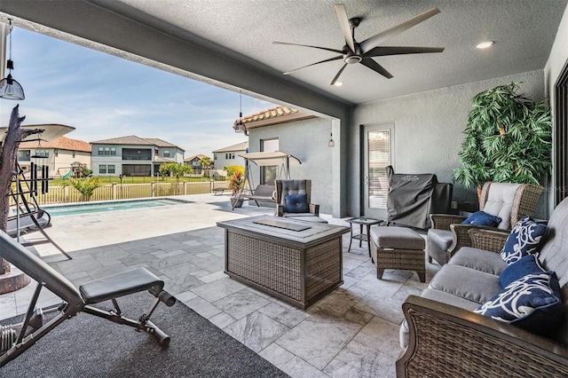 29043 Picana Ln, Wesley Chapel, FL 33543 - fenced backyard with a ceiling fan, a patio area, an outdoor living space, and a residential view