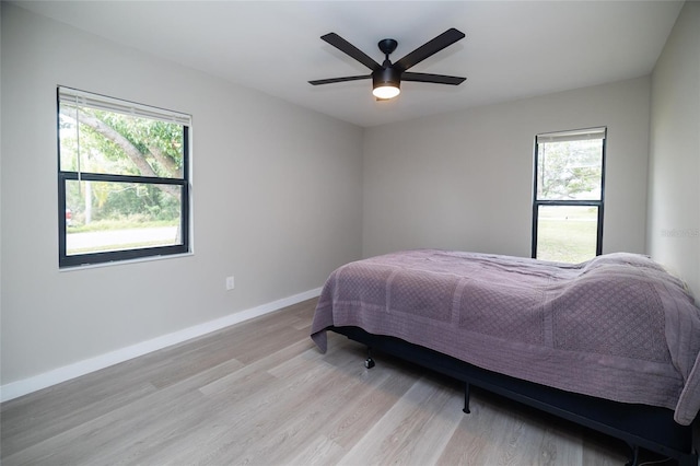 1403 Cummings Ave, Avon Park, FL 33825 - bedroom with light wood-type flooring, baseboards, and ceiling fan