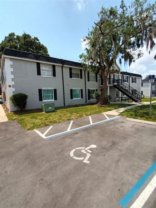 7636 Forest City Rd 072 A/K/A Unit H, Orlando, FL 32810 - uncovered parking lot featuring stairway