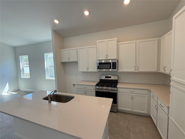 931 Azalea Walk Cir, Deland, FL 32724 - kitchen with appliances with stainless steel finishes, a sink, tasteful backsplash, white cabinetry, and light countertops