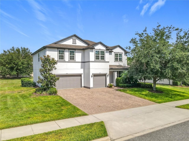 3184 Pinenut Dr, Apopka, FL 32712 - traditional-style home featuring stucco siding, an attached garage, decorative driveway, and a front lawn