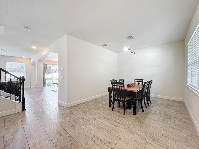3184 Pinenut Dr, Apopka, FL 32712 - dining area with arched walkways, stairs, and baseboards