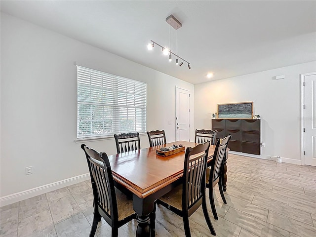 3184 Pinenut Dr, Apopka, FL 32712 - dining area featuring baseboards and rail lighting
