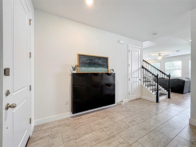 3184 Pinenut Dr, Apopka, FL 32712 - foyer with baseboards, stairway, and ceiling fan