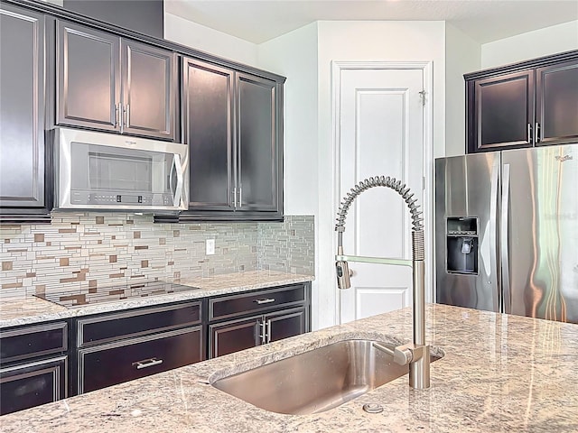 3184 Pinenut Dr, Apopka, FL 32712 - kitchen with stainless steel appliances, a sink, and light stone counters