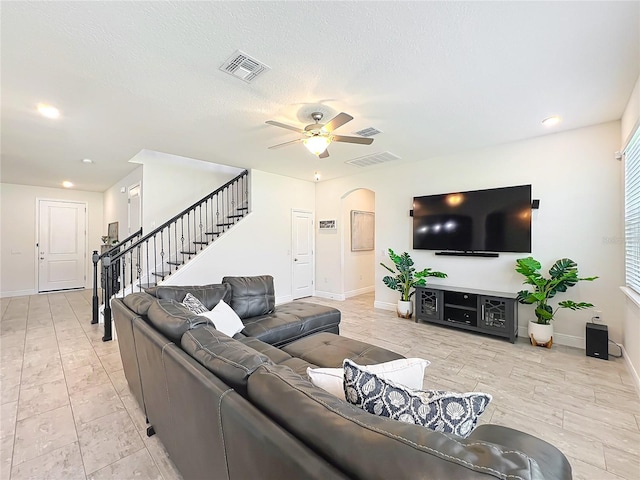 3184 Pinenut Dr, Apopka, FL 32712 - living area featuring baseboards, arched walkways, ceiling fan, stairs, and recessed lighting
