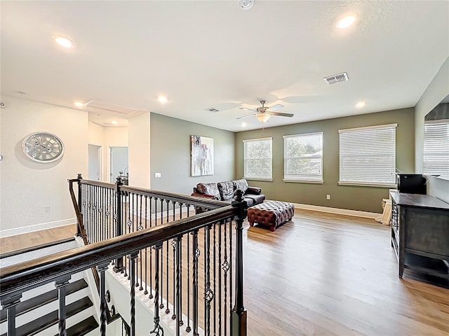 3184 Pinenut Dr, Apopka, FL 32712 - hall featuring light wood-style flooring, baseboards, recessed lighting, and an upstairs landing