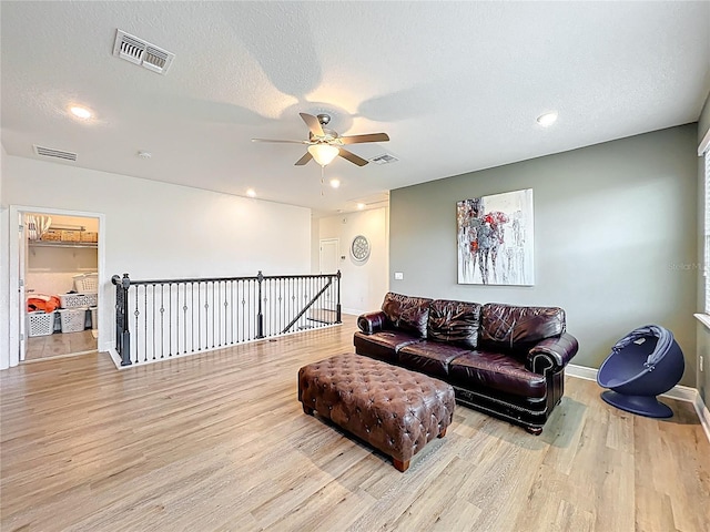 3184 Pinenut Dr, Apopka, FL 32712 - living area with wood finished floors, ceiling fan, baseboards, recessed lighting, and a textured ceiling
