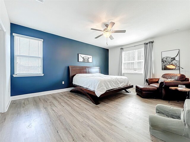 3184 Pinenut Dr, Apopka, FL 32712 - bedroom with wood finished floors, a ceiling fan, and baseboards