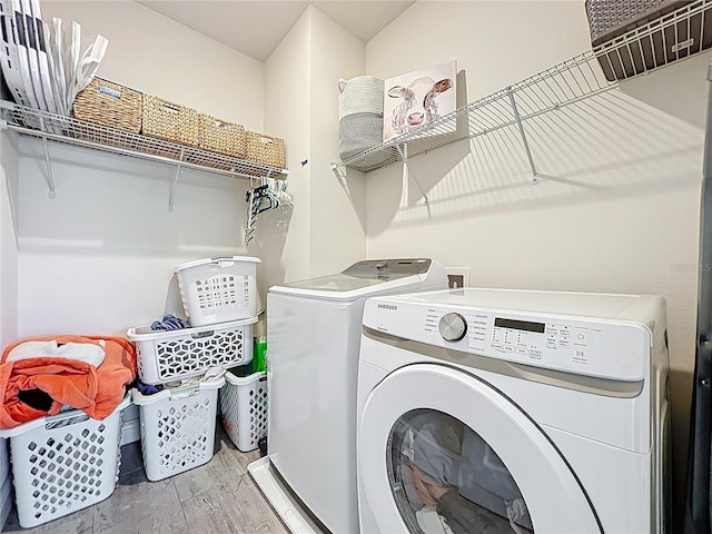 3184 Pinenut Dr, Apopka, FL 32712 - laundry room with washing machine and dryer and wood finished floors