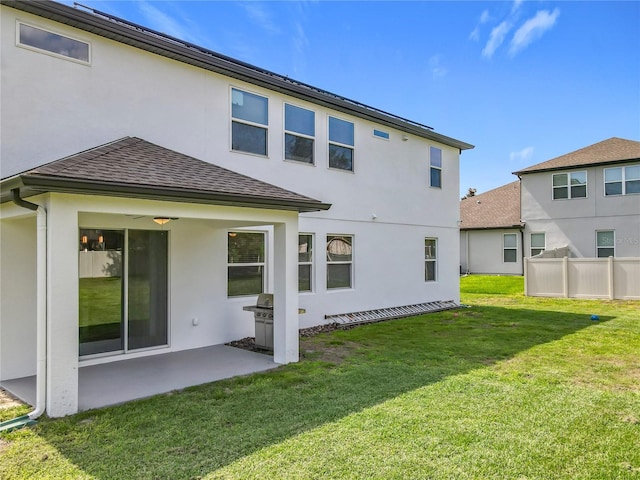 3184 Pinenut Dr, Apopka, FL 32712 - rear view of house with a patio, stucco siding, a yard, and roof with shingles