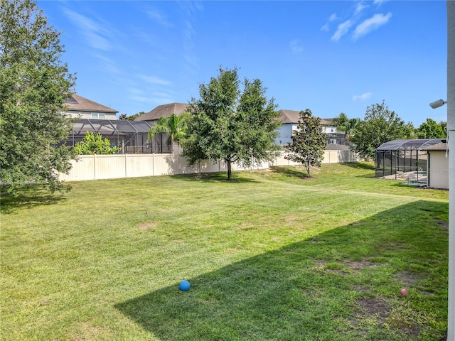 3184 Pinenut Dr, Apopka, FL 32712 - view of yard featuring glass enclosure and a residential view
