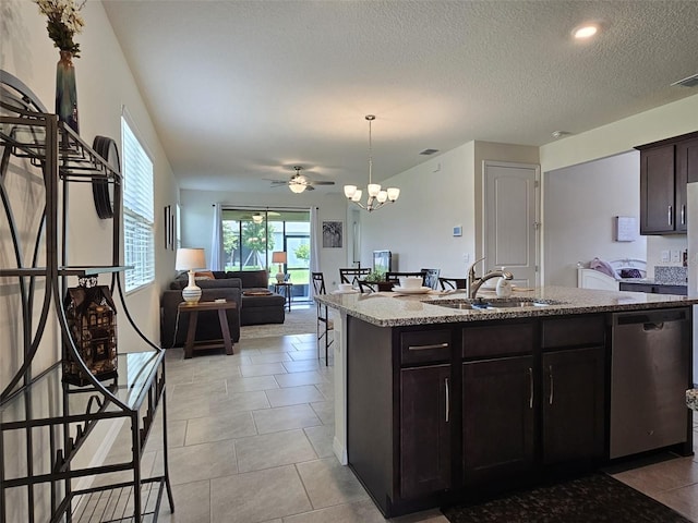 3371 Yellowtop Loop, Clermont, FL 34714 - kitchen featuring a sink, dishwasher, light stone counters, ceiling fan, and a textured ceiling